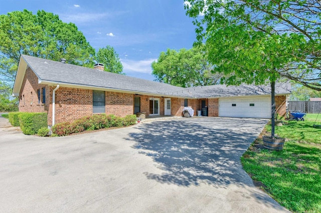 1062 Jp Cave Rd, Sherman, TX 75090 - single story home featuring brick siding, an attached garage, concrete driveway, and a chimney