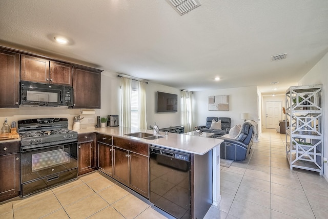 kitchen featuring sink, black appliances, kitchen peninsula, and light tile patterned flooring