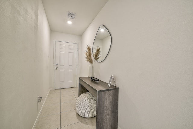 doorway featuring light tile patterned flooring