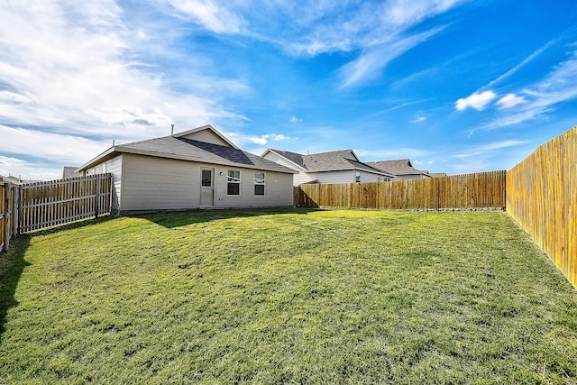 back of house featuring a yard