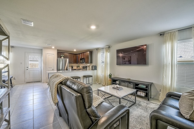 living room featuring light tile patterned floors and plenty of natural light