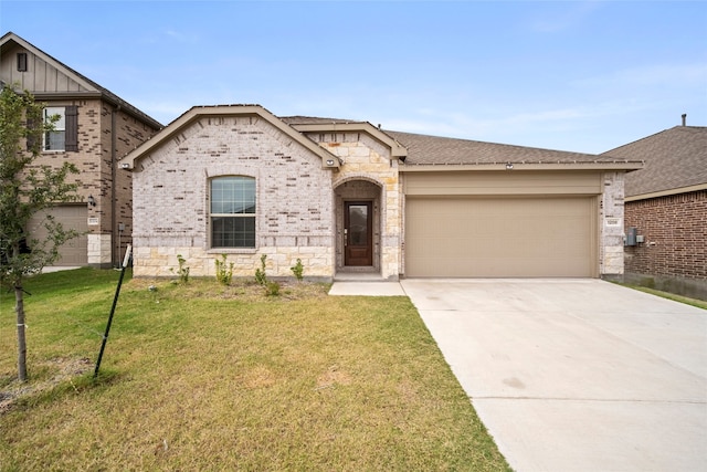 view of front of home with a front yard and a garage