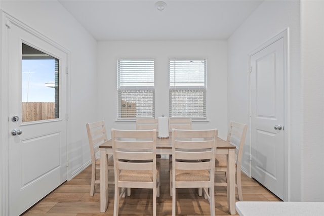 dining space with light hardwood / wood-style flooring