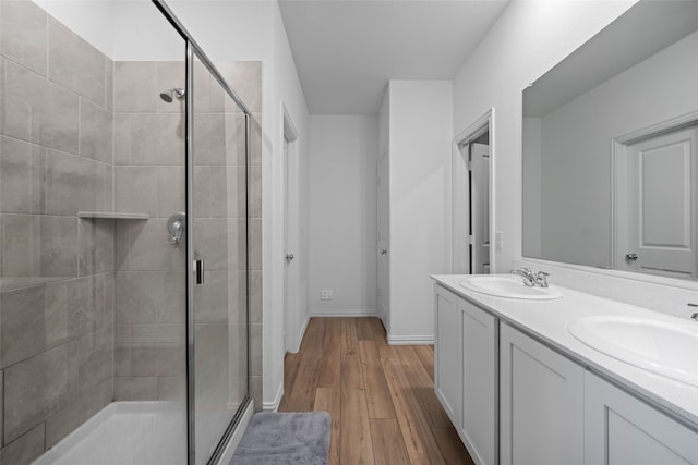 bathroom featuring vanity, an enclosed shower, and hardwood / wood-style floors