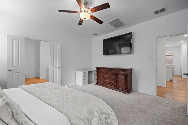 bedroom with ceiling fan and light colored carpet