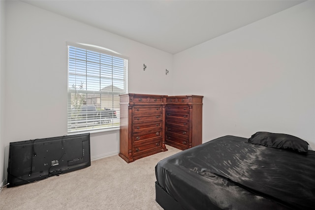 carpeted bedroom featuring multiple windows