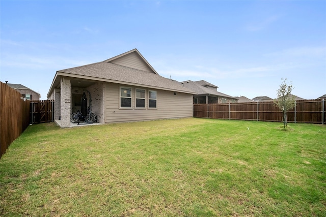 back of house featuring a yard