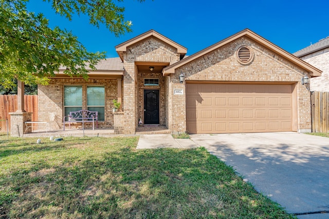 view of front of house featuring a front yard and a garage