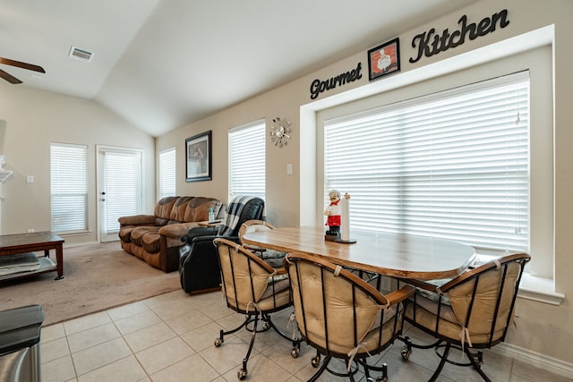 dining area with lofted ceiling, light tile patterned flooring, and ceiling fan