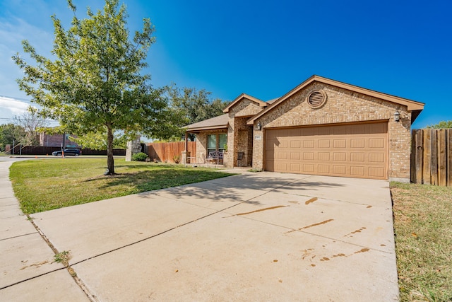 ranch-style house featuring a front yard and a garage