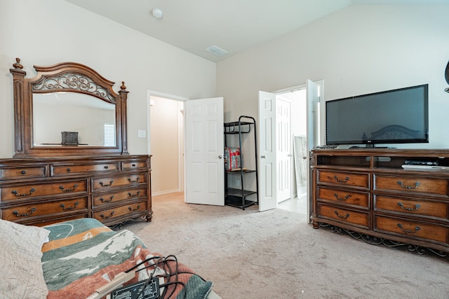 bedroom with light carpet and lofted ceiling