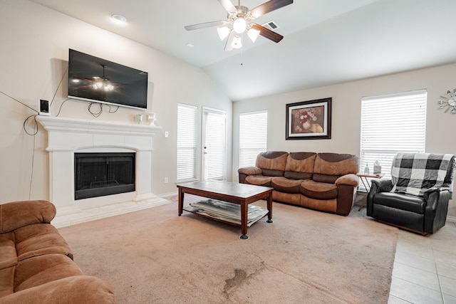 tiled living room featuring ceiling fan, a healthy amount of sunlight, and lofted ceiling