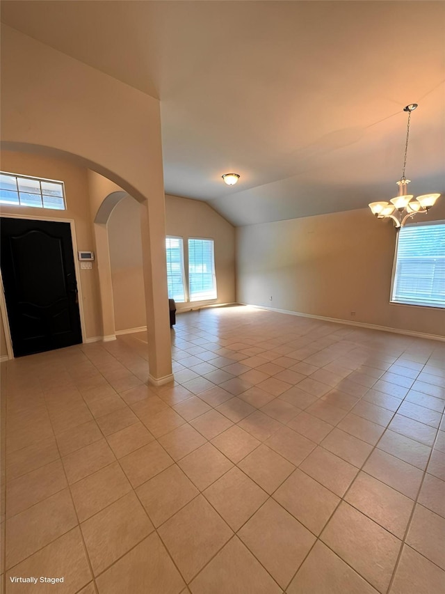 602 Tumbleweed Dr, Forney, TX 75126 - entrance foyer featuring arched walkways, a chandelier, light tile patterned floors, and vaulted ceiling