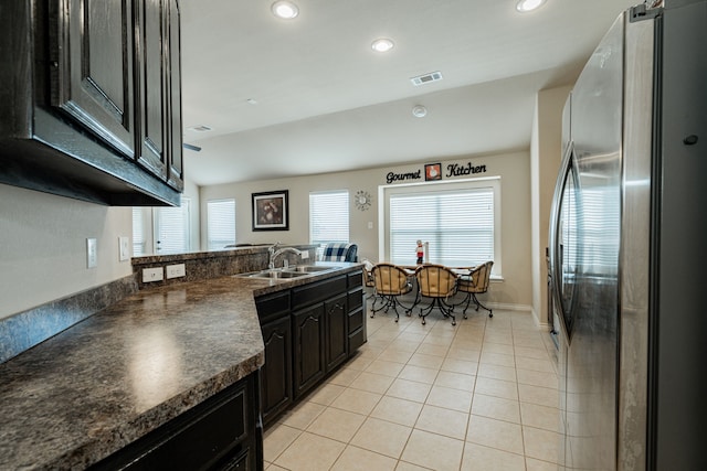 602 Tumbleweed Dr, Forney, TX 75126 - kitchen featuring freestanding refrigerator, dark countertops, light tile patterned floors, recessed lighting, and dark cabinets