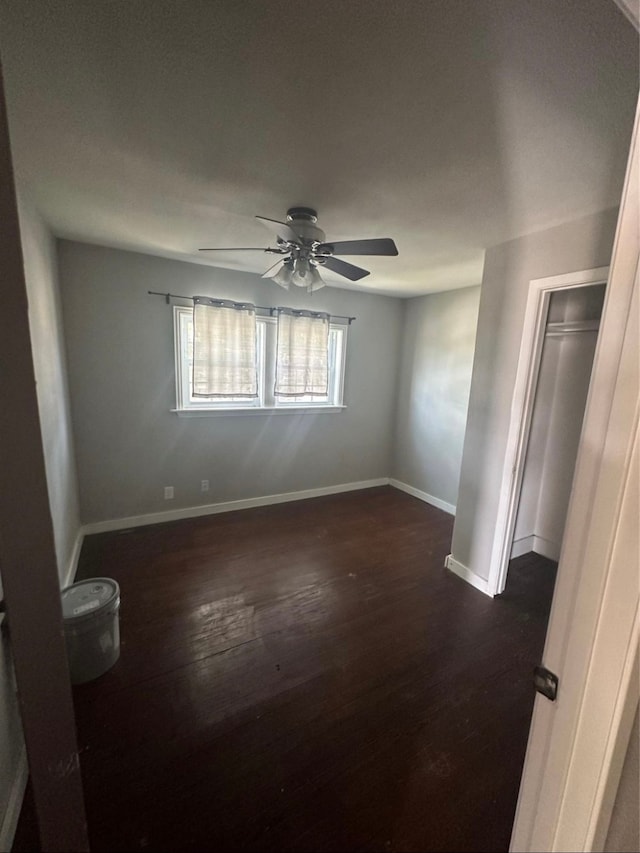 spare room with dark hardwood / wood-style floors and ceiling fan