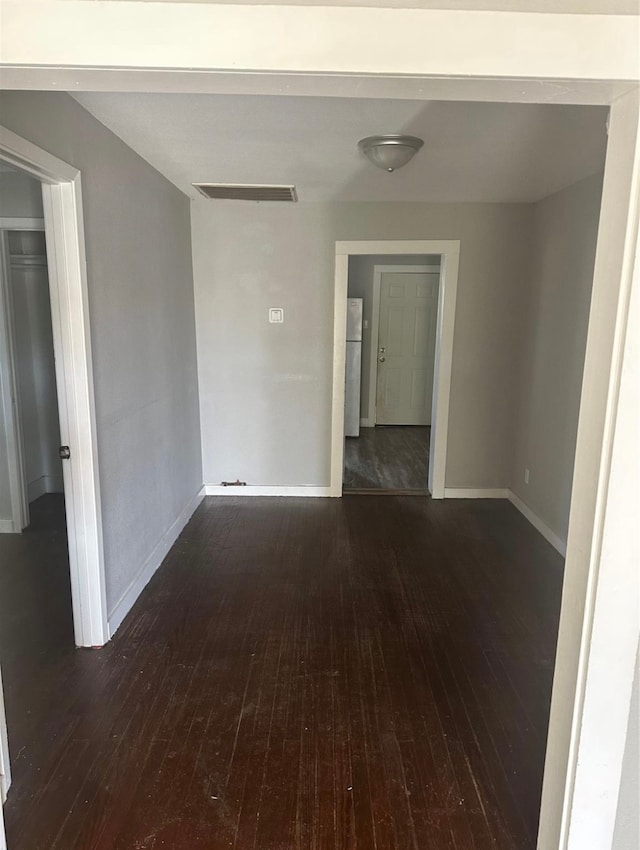 empty room featuring dark hardwood / wood-style flooring