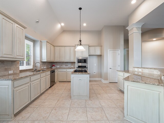 kitchen with sink, a center island, hanging light fixtures, stainless steel appliances, and decorative columns