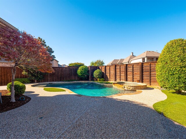 view of pool with an in ground hot tub and a patio area