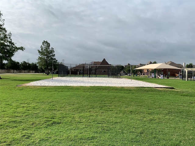 view of community with a lawn and volleyball court