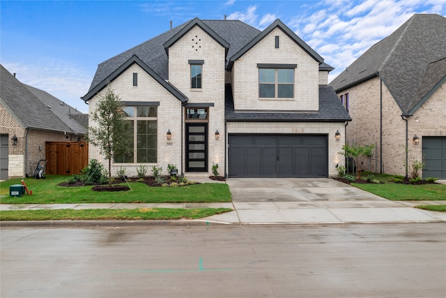 view of front facade with a front yard and a garage