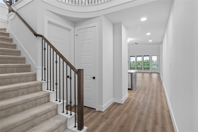 interior space with high vaulted ceiling and hardwood / wood-style flooring