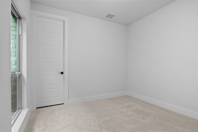 spare room with light carpet