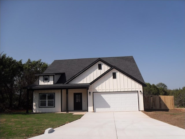 view of front facade with a garage and a front lawn