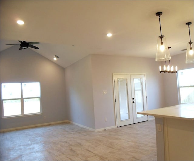 kitchen with ceiling fan, a healthy amount of sunlight, vaulted ceiling, and pendant lighting