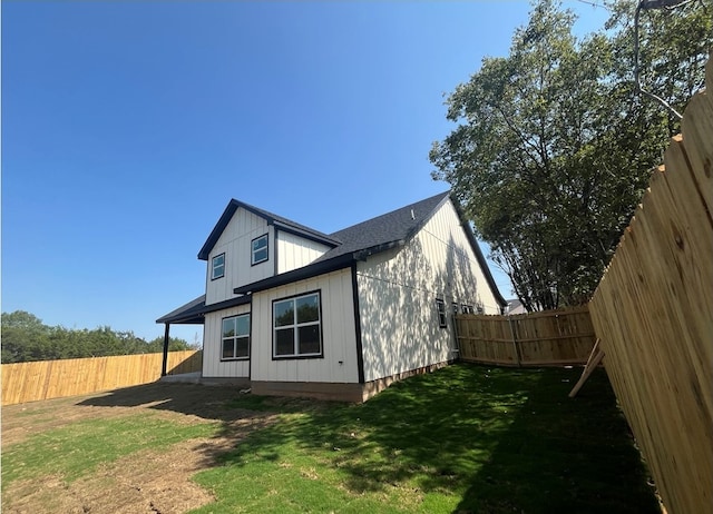 view of side of property with a lawn