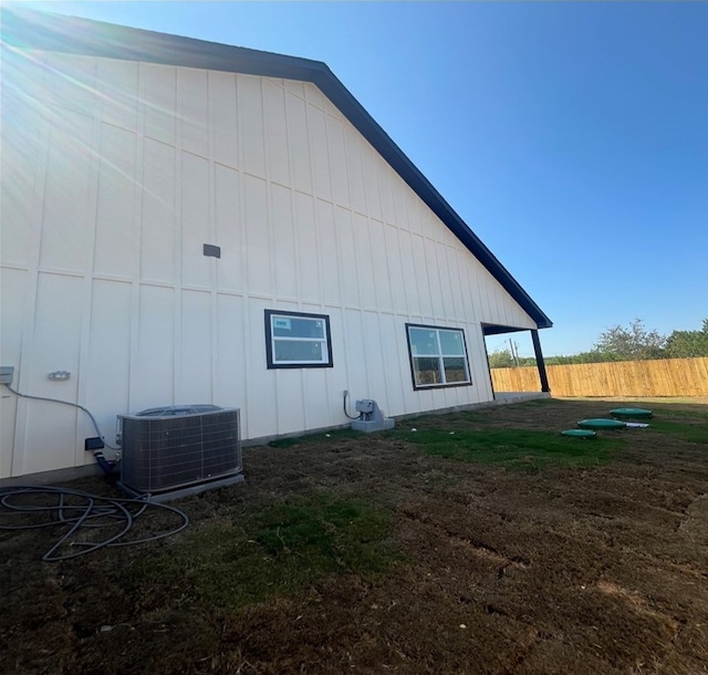 view of side of property with central air condition unit