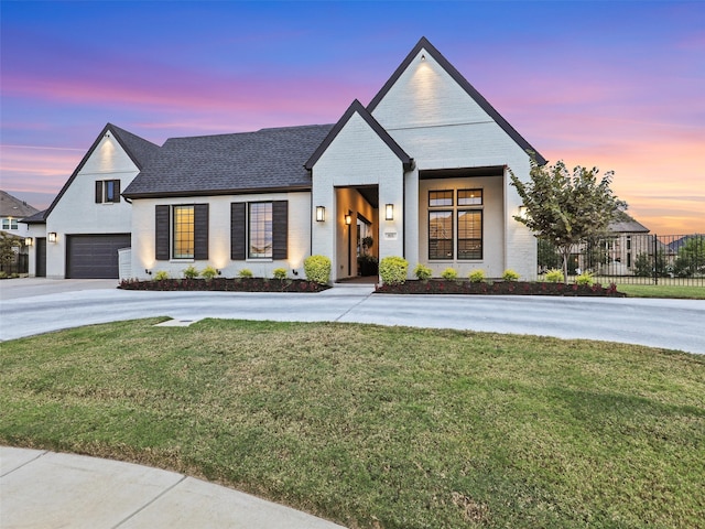 modern farmhouse with a yard and a garage