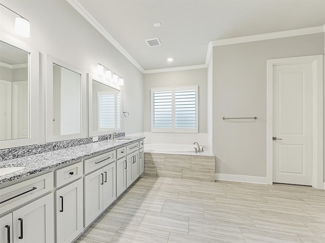 bathroom with vanity, ornamental molding, and tiled bath