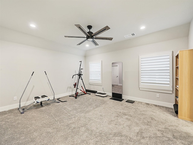 exercise area with a healthy amount of sunlight, carpet flooring, and ceiling fan