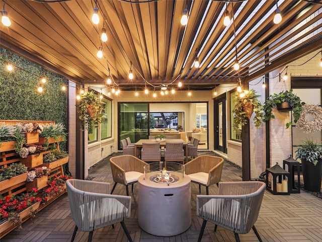 view of patio / terrace with an outdoor living space with a fire pit and a pergola