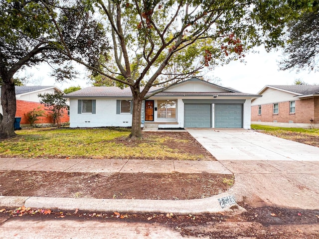 single story home with a front yard and a garage