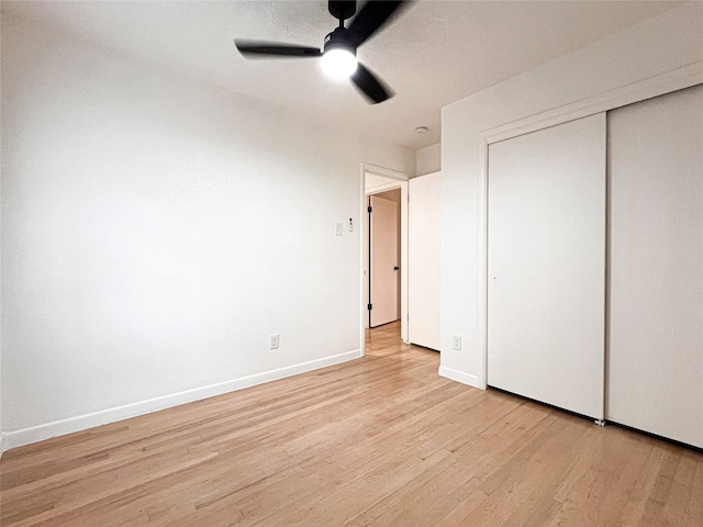 unfurnished bedroom featuring light hardwood / wood-style flooring, a closet, and ceiling fan