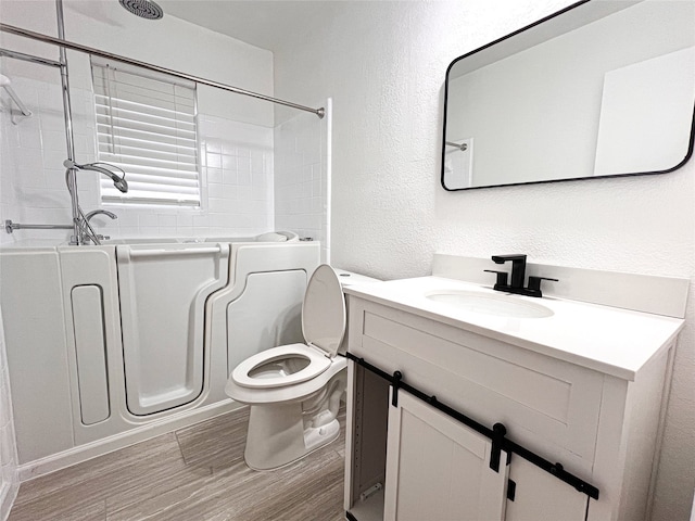 full bathroom featuring vanity, shower / tub combination, wood-type flooring, and toilet