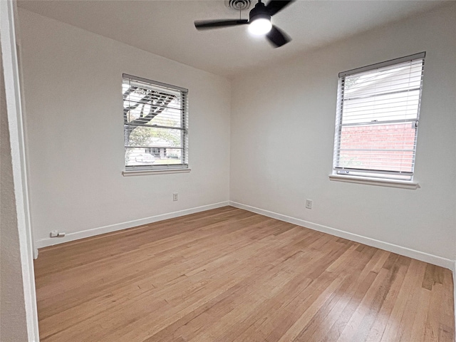 unfurnished room featuring ceiling fan, a healthy amount of sunlight, and light wood-type flooring