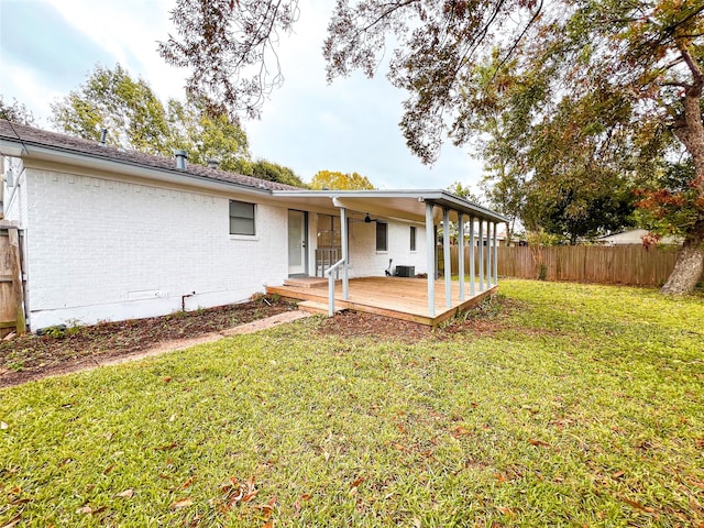 back of house featuring central AC, a yard, and a deck