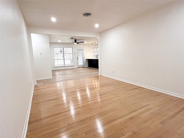 unfurnished living room featuring light hardwood / wood-style floors and ceiling fan