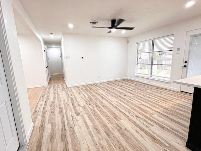 unfurnished living room with light hardwood / wood-style flooring and ceiling fan