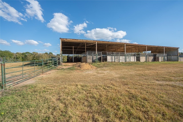 view of horse barn with a rural view