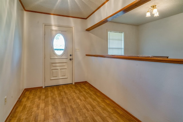 entrance foyer featuring a textured ceiling and light wood-type flooring