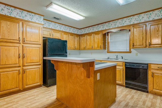 kitchen featuring crown molding, a center island, light hardwood / wood-style flooring, and black appliances