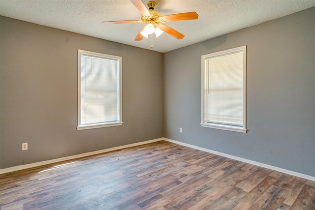 spare room with hardwood / wood-style flooring, ceiling fan, and a textured ceiling