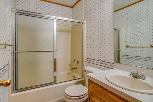 full bathroom featuring toilet, shower / bath combination with glass door, a textured ceiling, ornamental molding, and vanity