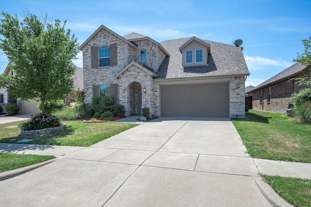 view of front of house featuring a front yard and a garage