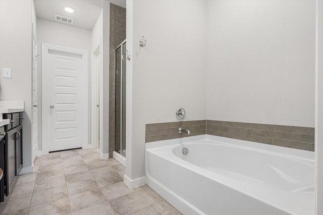 bathroom featuring vanity, independent shower and bath, and tile patterned flooring