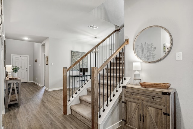 staircase featuring hardwood / wood-style floors