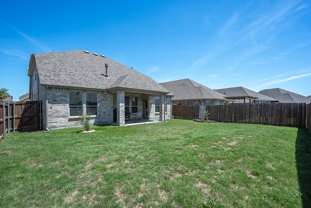 rear view of house featuring a patio area and a lawn